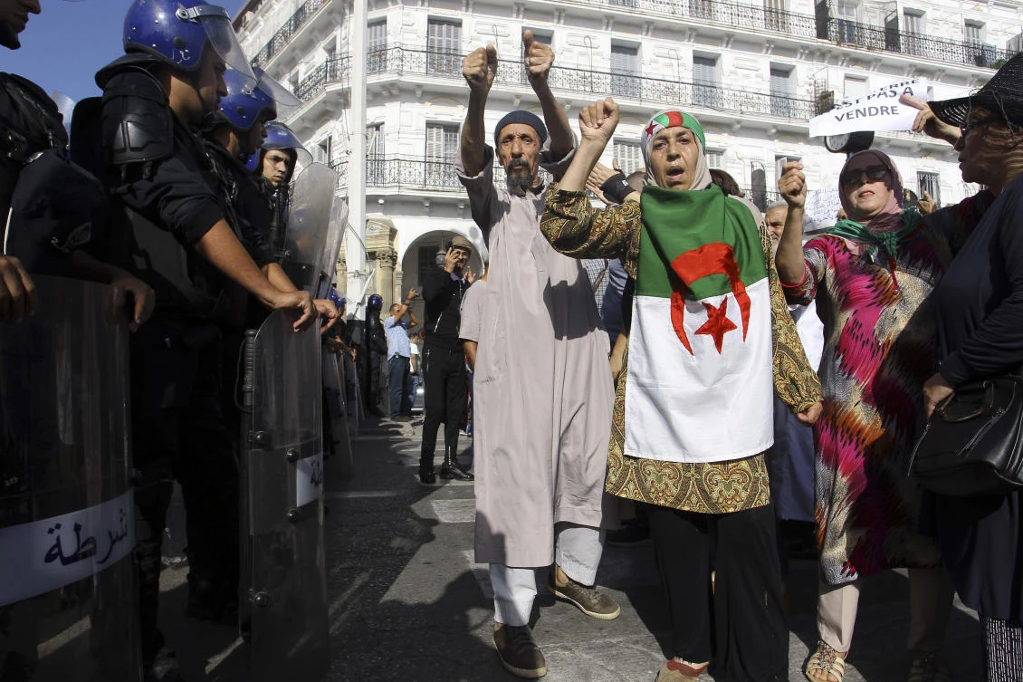 Algerians take part to a protest in front of their parliament against a bill aimed at attracting foreign investment to the oil and gas sector, which underpins the national economy in Algiers, Sunday, Oct. 13, 2019. (AP)