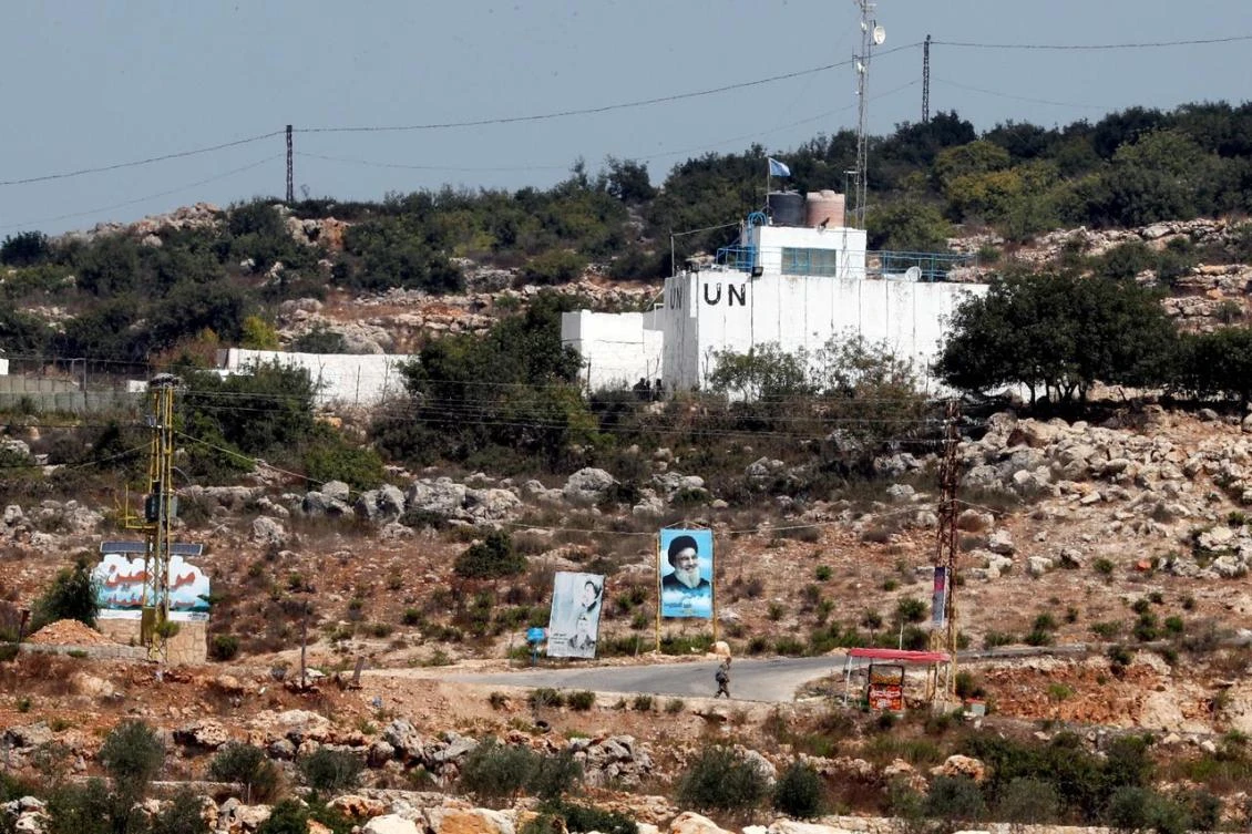 A banner depicting Hezbollah leader Sayyed Hassan Nasrallah and an United Nation's post are seen in Lebanon from the Israeli side of the border, near Zar'it in northern Israel August 28, 2019. (Reuters)