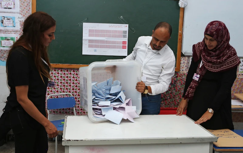 An election official empties a ballot box after polls closed during a second round runoff of a presidential election in Tunis, Tunisia October 13, 2019. (Reuters)