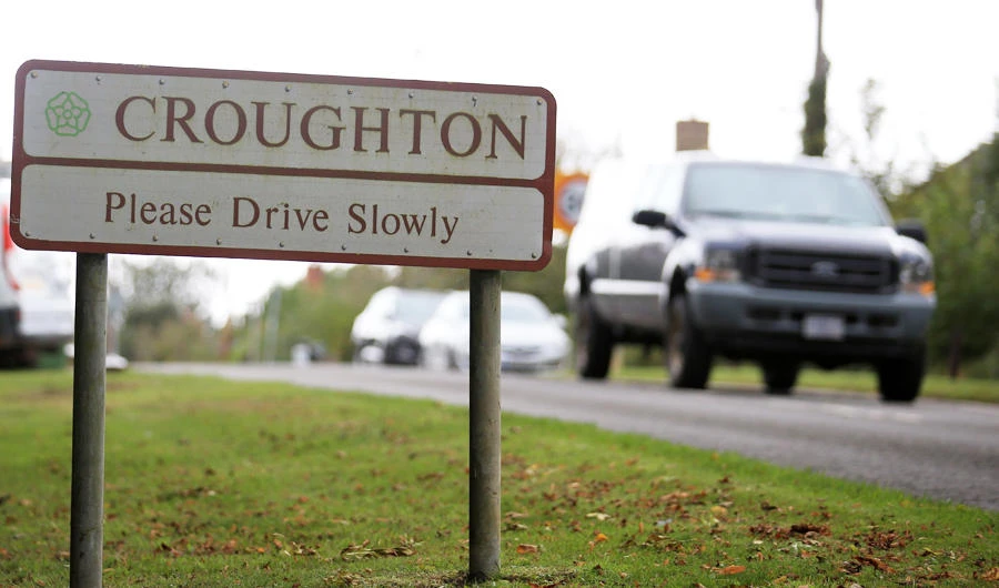 A road sign asking drivers to drive slowly is pictured in the villgae of Croughton in Northamptonshire, central England on October 10, 2019, near to where British motorcyclist Harry Dunn was killed as he travelled along the B4031 on August 27. (AFP)