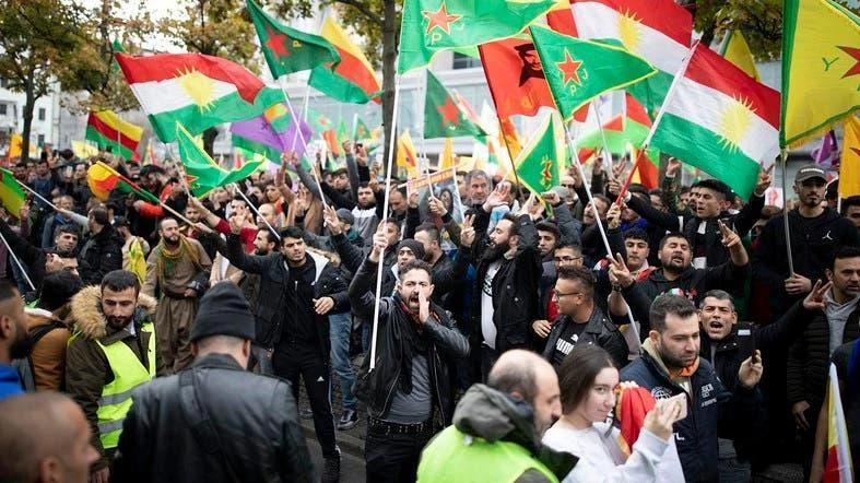 Protesters wave flags as they take part in a rally in Berlin in support of the Kurdish cause as Turkey continues its offensive in northeastern Syria. (AFP)