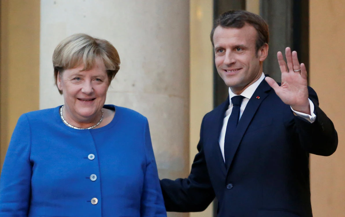 French President Emmanuel Macron welcomes German Chancellor Angela Merkel as she arrives for a dinner to discuss European matters ahead of next week’s EU Summit, at the Elysee Palace in Paris, France, October 13, 2019. (Reuters)