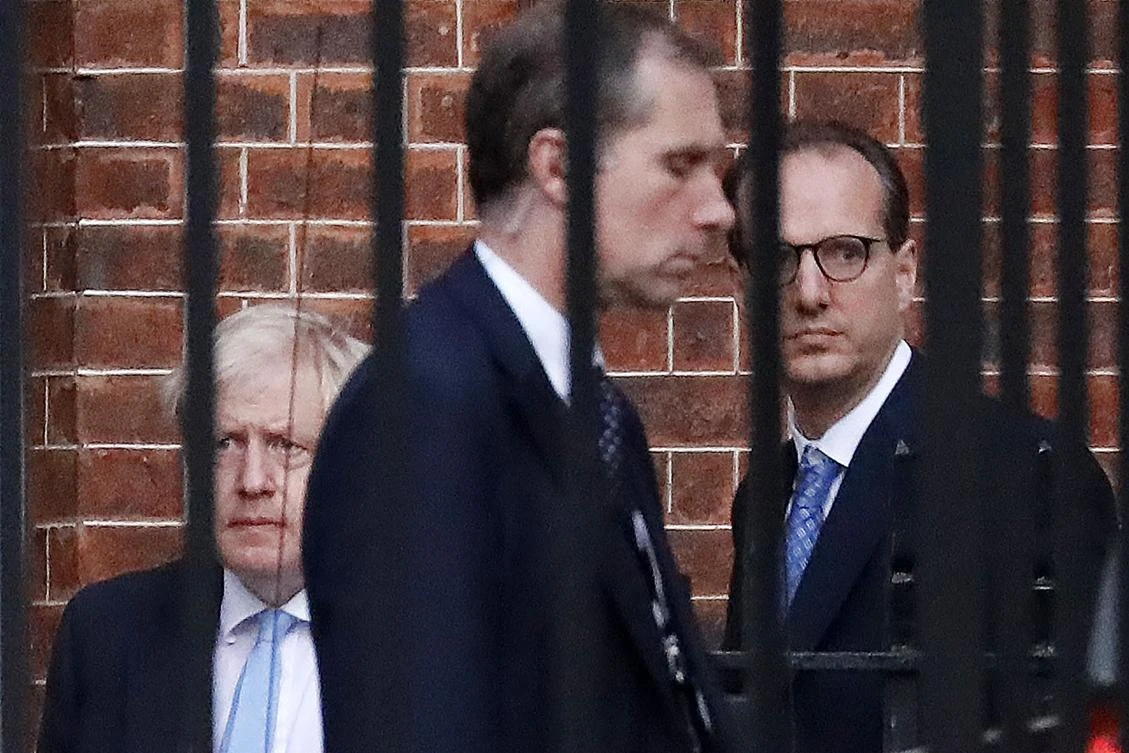 Boris Johnson leaves from the rear of 10 Downing Street where he briefed his ministers on details of a Brexit deal taking shape in Brussels, while warning an agreement was still ‘shrouded in mist’. (AFP)