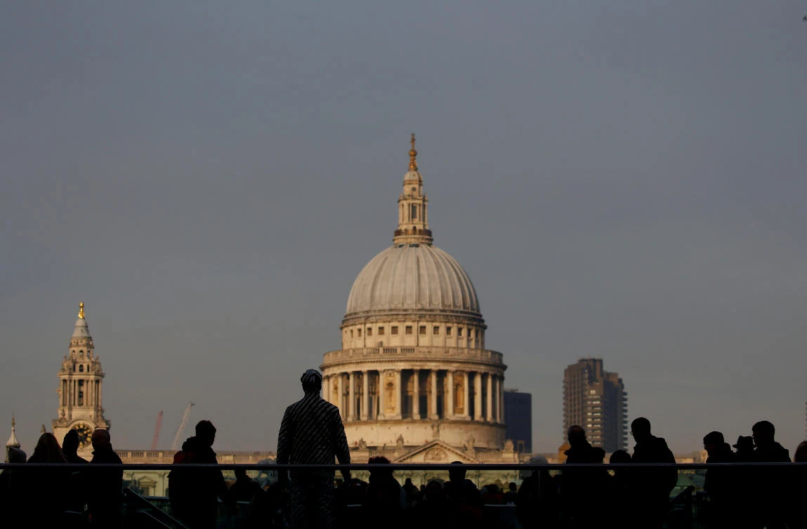 Pedestrians use the Millennium Bridge on the South Bank, opposite St. Paul’s Cathedral, in London. (Reuters)