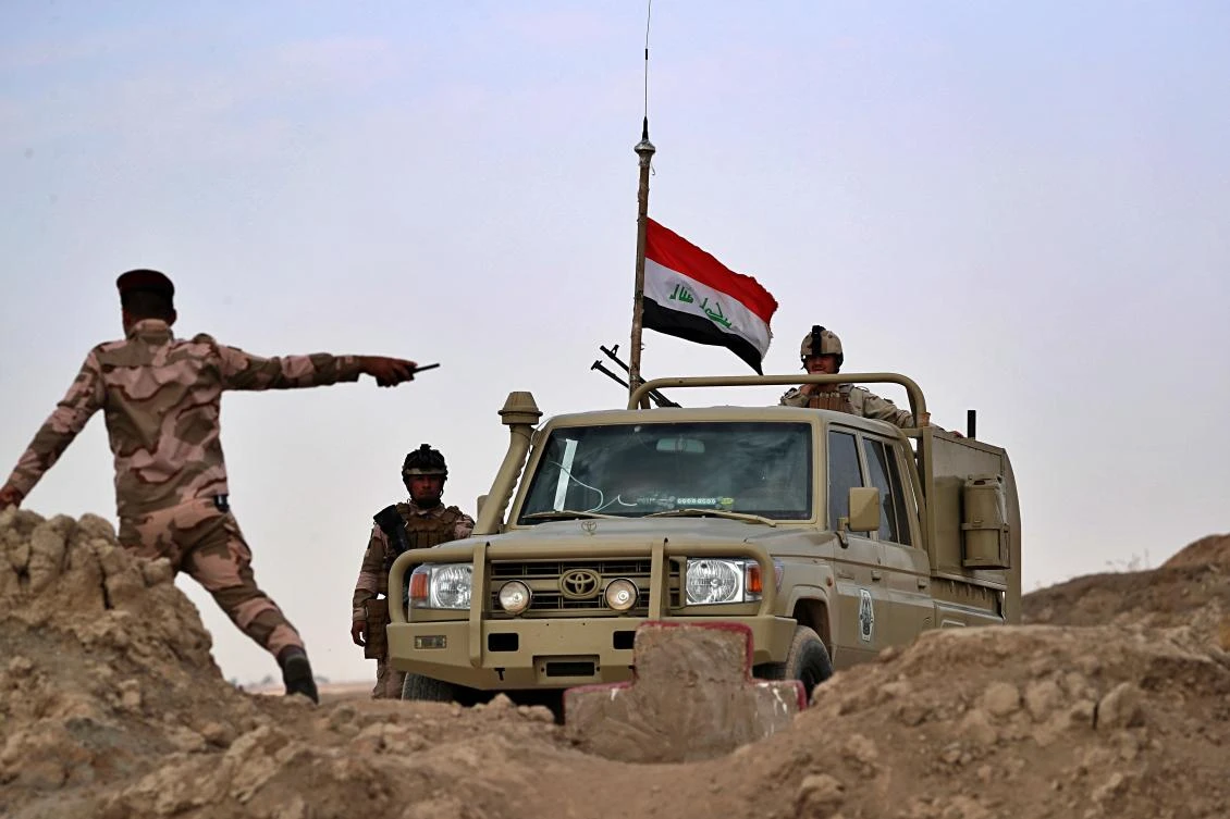 Iraqi security forces secure the Iraq-Syria border around the Rabiaa border crossing on Wednesday. (AP)