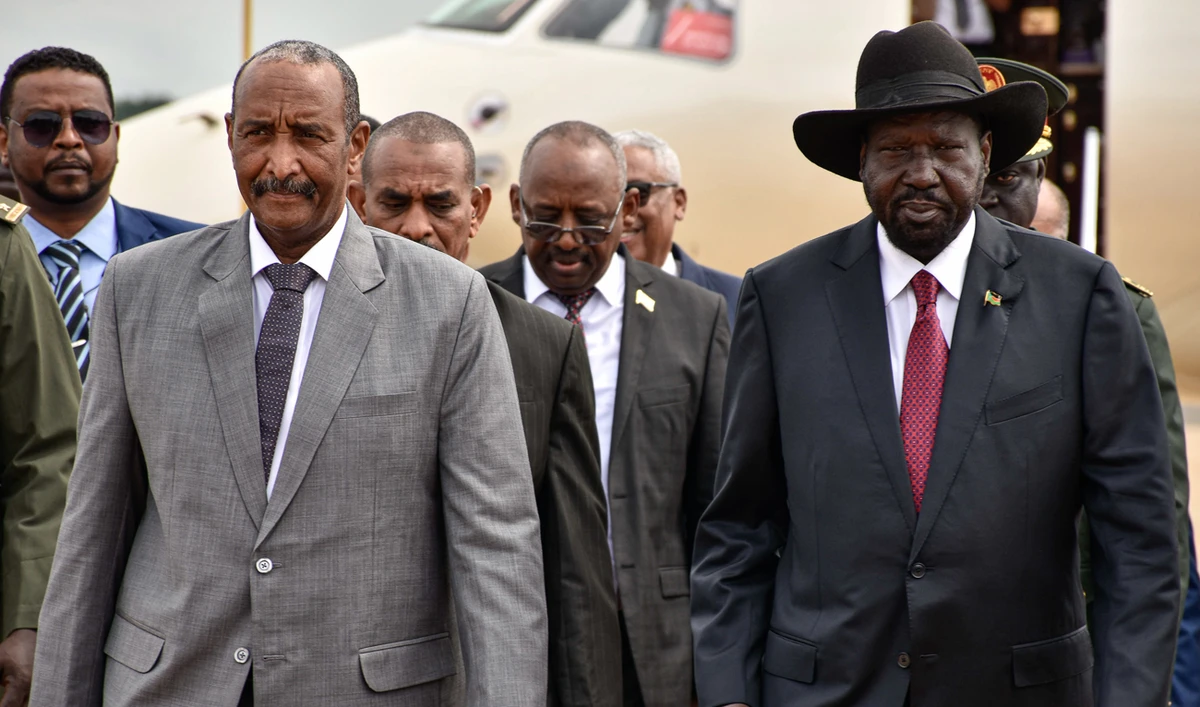 President of Sudanese Transitional Council General Abdel Fattah al-Burhan (L) is welcomed by President of South Sudan Salva Kiir (R) at his arrival for the summit to endorse the peace talks between Sudan's government and rebel leaders in Juba, South Sudan, on October 14, 2019. (AFP)