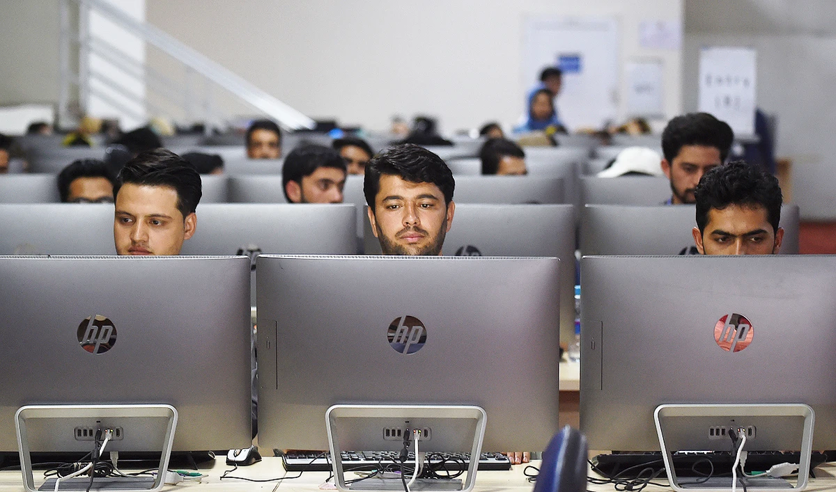 Independent Election Commission (IEC) workers sit at a computer terminal while election information from all over the country is gathered at the Data Centre in Kabul on October 2, 2019. (AFP)