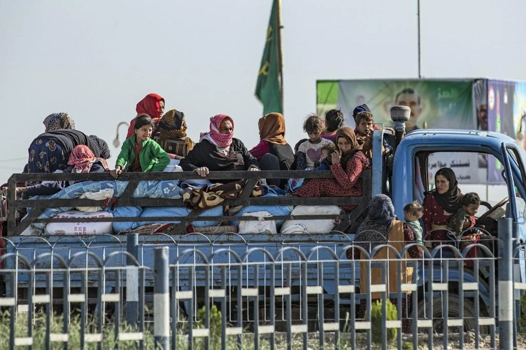 Syrian families fleeing the battle zone between Turkey-led forces and Kurdish fighters from the Syrian Democratic Forces (SDF) in and around the northern flashpoint town of Ras al-Ain on the border with Turkey. (File/AFP)