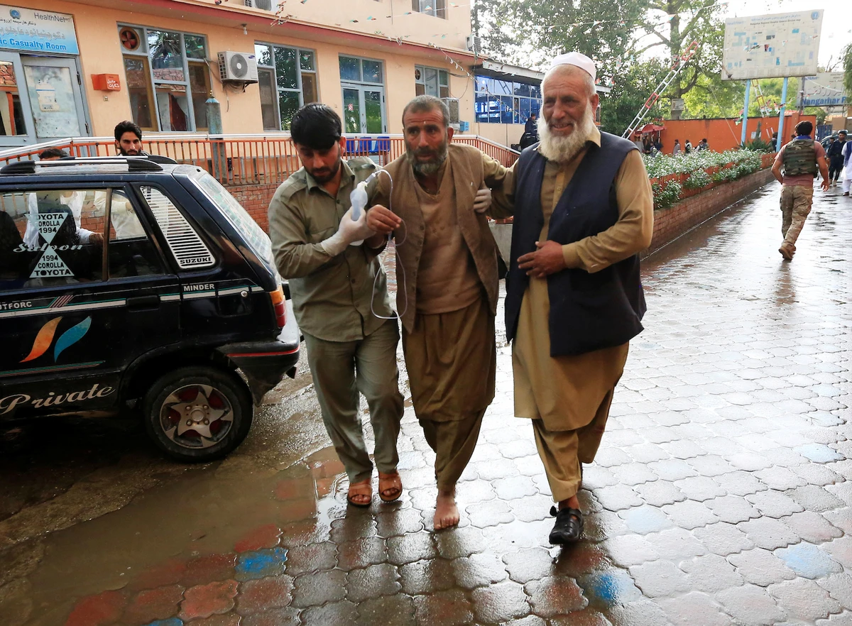 Men carry an injured person to a hospital after a bomb blast at a mosque, in Jalalabad, Afghanistan October 18, 2019. (Reuters)