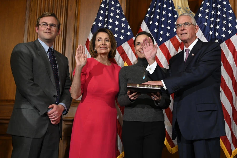 In this Jan. 3, 2019 photo, House Speaker Nancy Pelosi, second from left, poses during a ceremonial swearing-in with Rep. Francis Rooney, right, on Capitol Hill in Washington. (AP Photo/Susan Walsh, File)