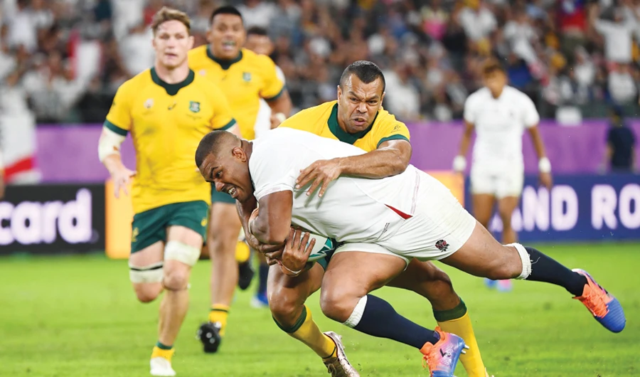 England’s prop Kyle Sinckler runs past Australia’s full back Kurtley Beale to score a try during Saturday’s quarterfinal match. (AFP)