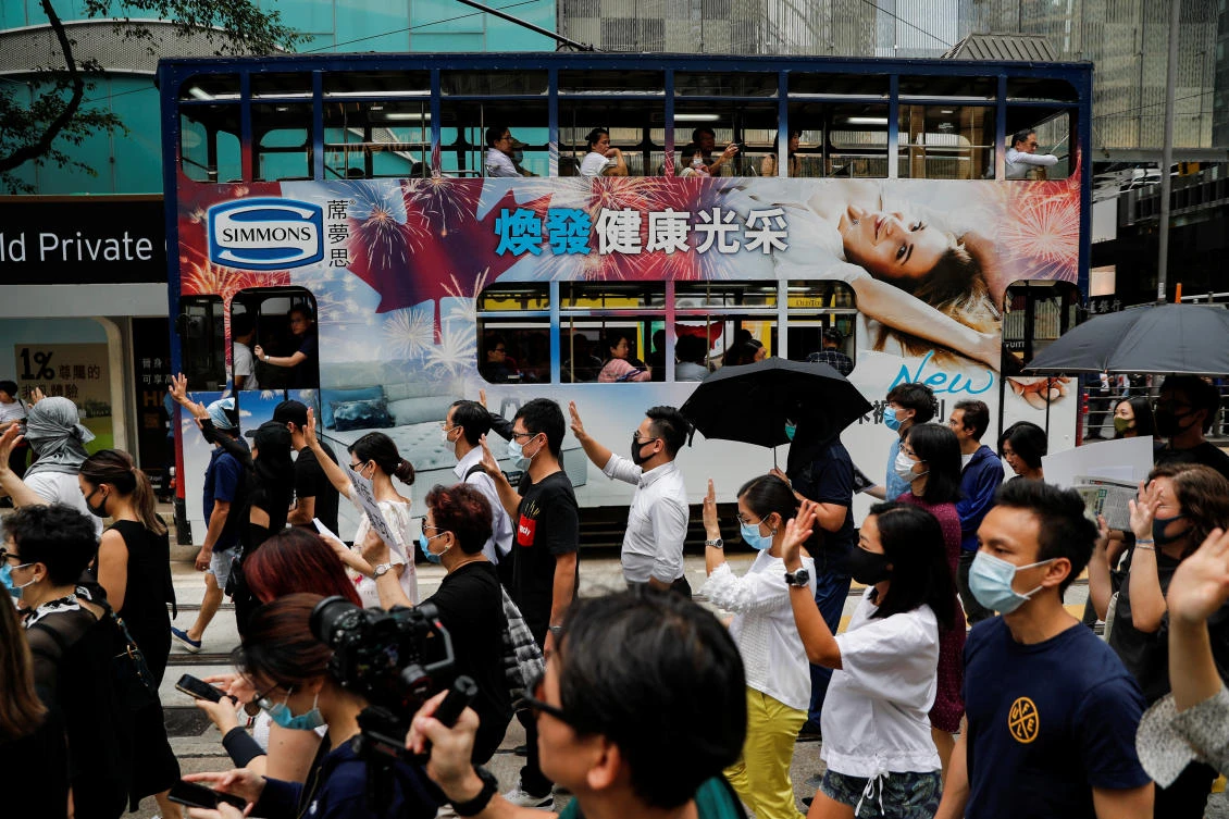 People march past a tram as they protest against what they say is the abuse of pro-democracy protesters by Hong Kong police, in Central district, Hong Kong, China October 18, 2019. (Reuters/Ammar Awad)