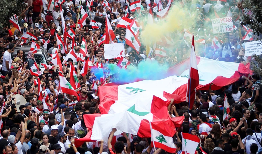Lebanese rally in Beirut on the 4th day of demonstrations against tax increases and official corruption, on Sunday. (AFP)