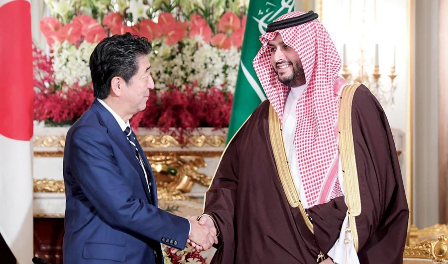 Japanese Prime Minister Shinzo Abe receives Prince Turki bin Mohammed bin Fahd bin Abdul Aziz, minister of state, in Tokyo on Monday. (SPA)