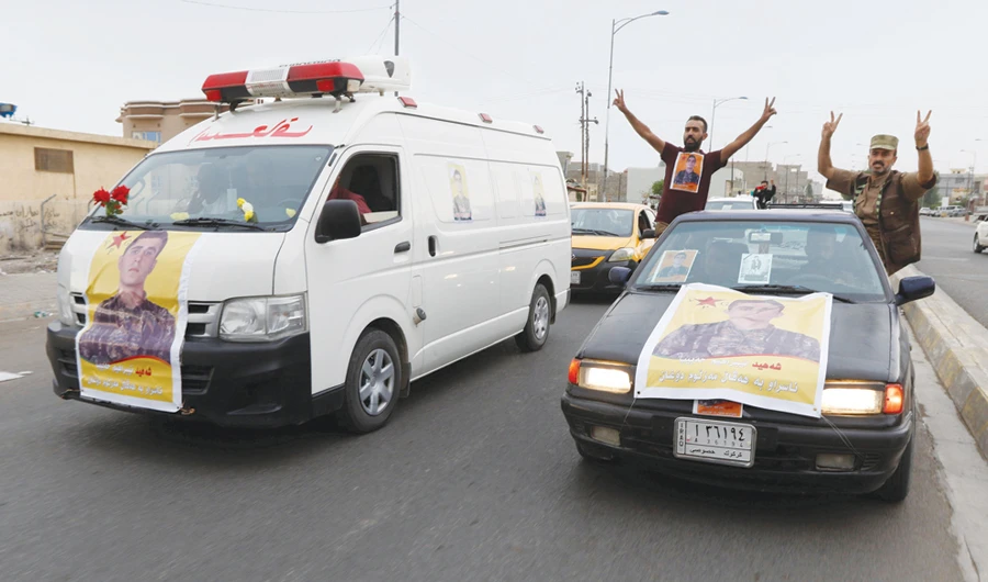 An ambulance carries a member of the Syrian Kurdish (YPG) militia, who was killed during clashes in Syria, before his funeral in Kirkuk, Iraq. Reuters