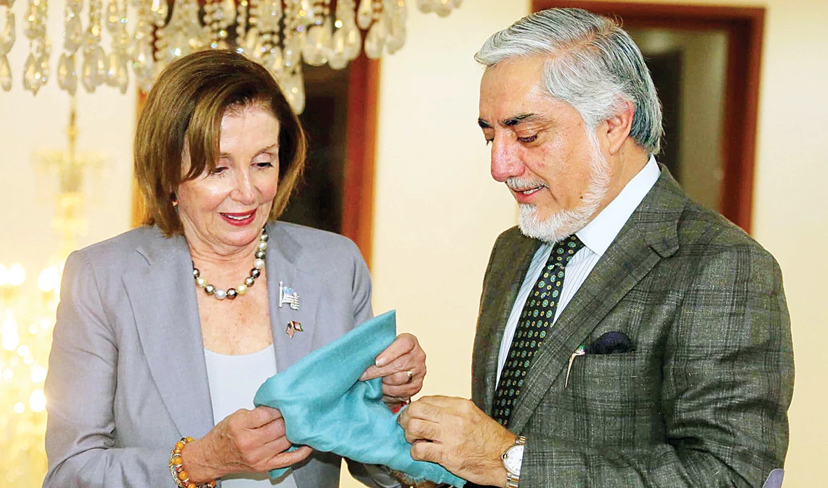 US House Speaker Nancy Pelosi receives a gift from Afghanistan Chief Executive Abdullah Abdullah in Kabul. (Reuters)