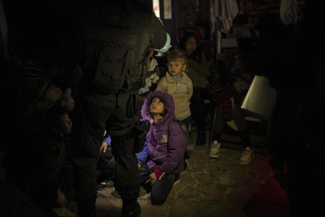 In this early Thursday, Oct. 3, 2019 photo, a Frontex coast guard counts migrants and refugees in the tiny harbor of Skala Sikamias, on the Greek island of Lesbos. (AP)