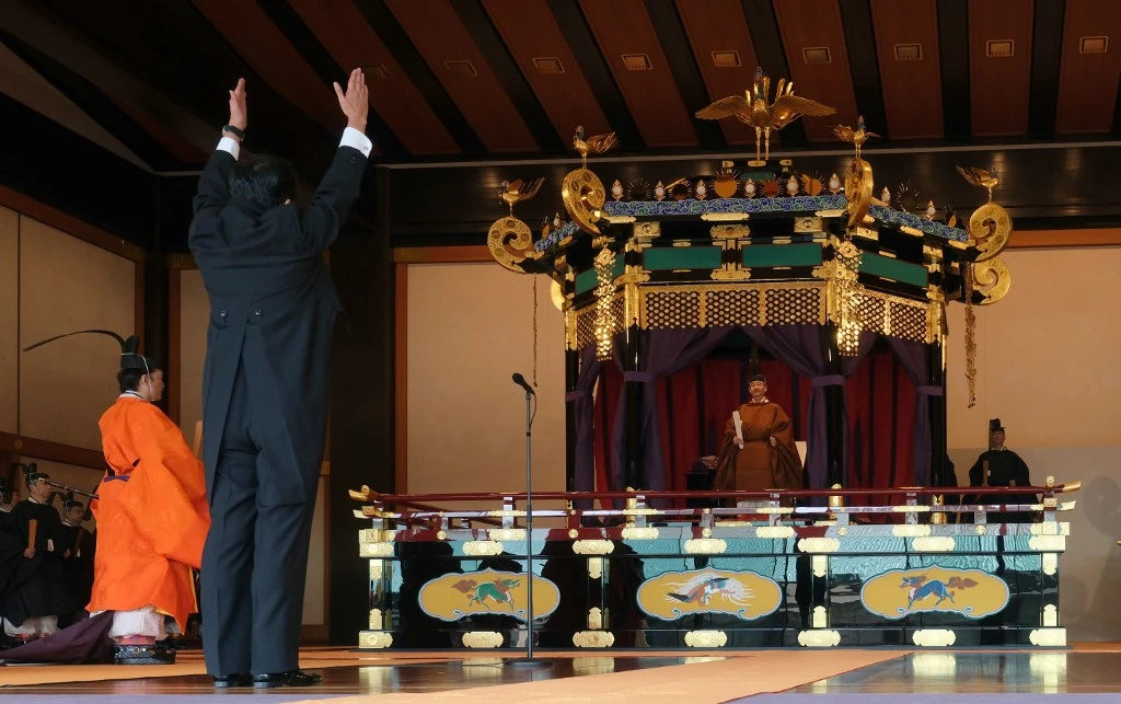 Prime Minister Shinzo Abe shouts a banzai cheer for Emperor Naruhito during the enthronement ceremony the emperor officially proclaimed his ascension to the Chrysanthemum Throne at the Imperial Palace in Tokyo on Tuesday, October 22, 2019. (AFP).