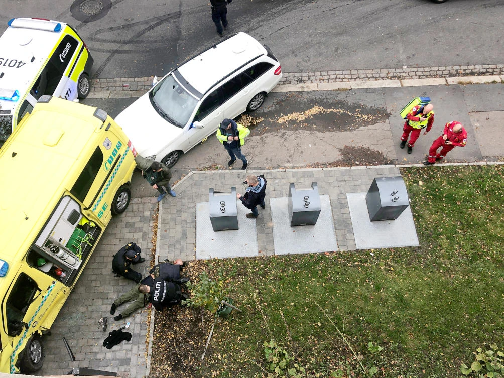 Police officers apprehend an armed man who stole an ambulance in Oslo, Norway. (Reuters)
