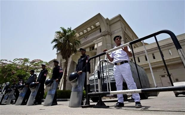 Egyptian riot policemen stand guard outside the constitutional court in Cairo on Sunday. (File photo: AFP)