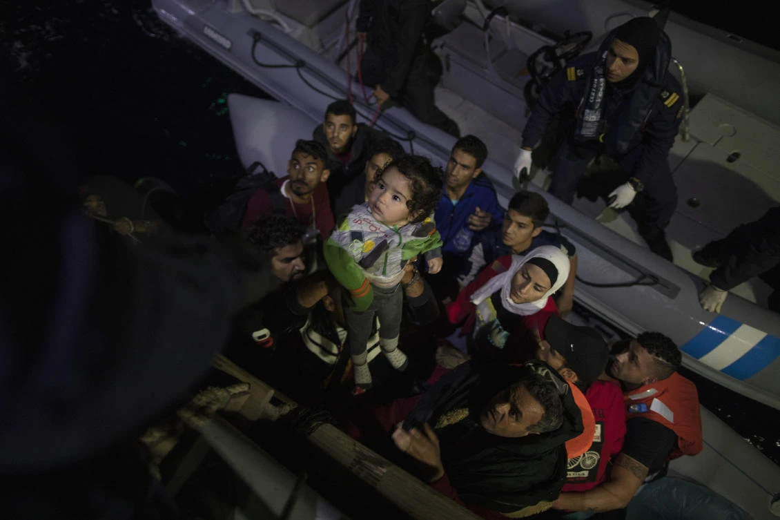 In this early Thursday, Sept. 26, 2019 photo, refugees and migrants are transferred from their dinghy onto a Greek coast guard patrol boat during a rescue operation near the eastern Aegean Sea island of Samos. (AP)