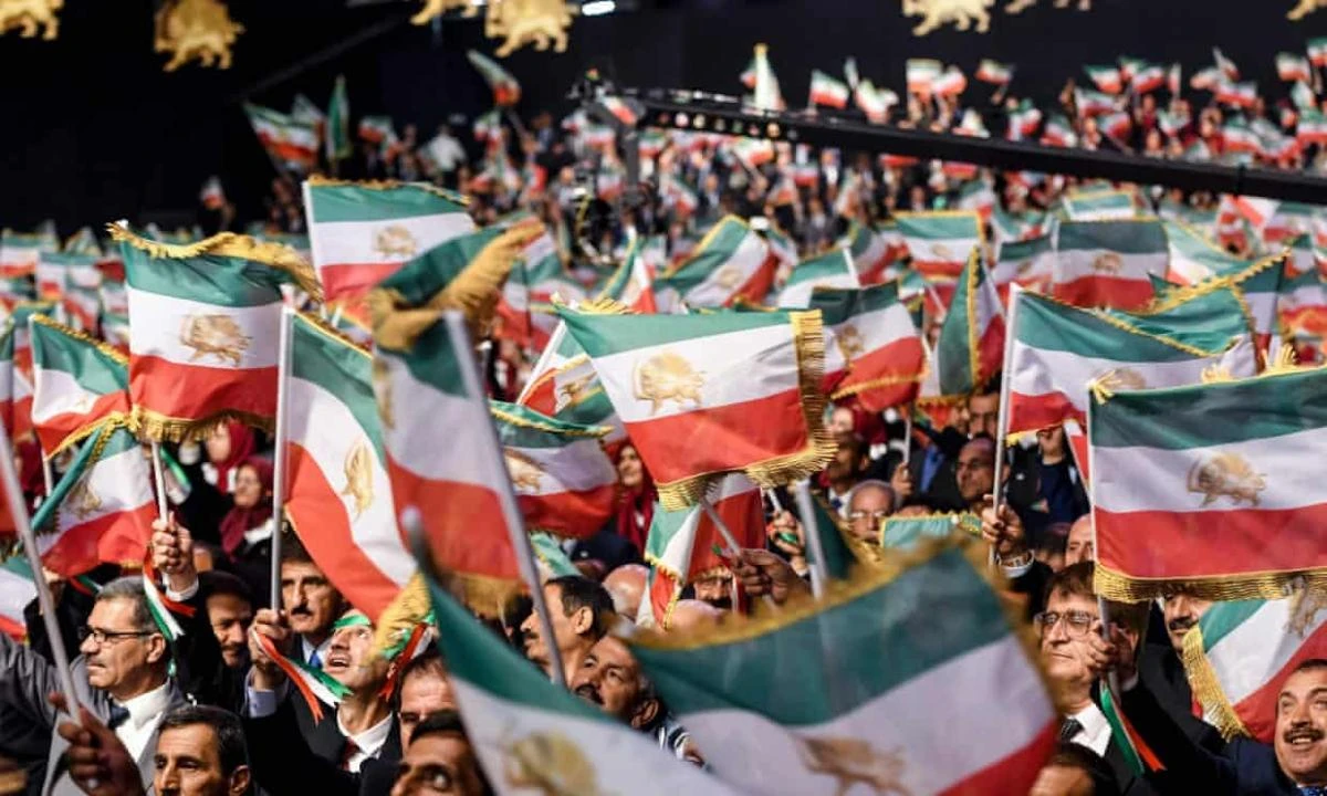 Members of the People’s Mujahedeen of Iran (MEK) waving Iranian flags at a camp in Manza, Albania. (AFP)