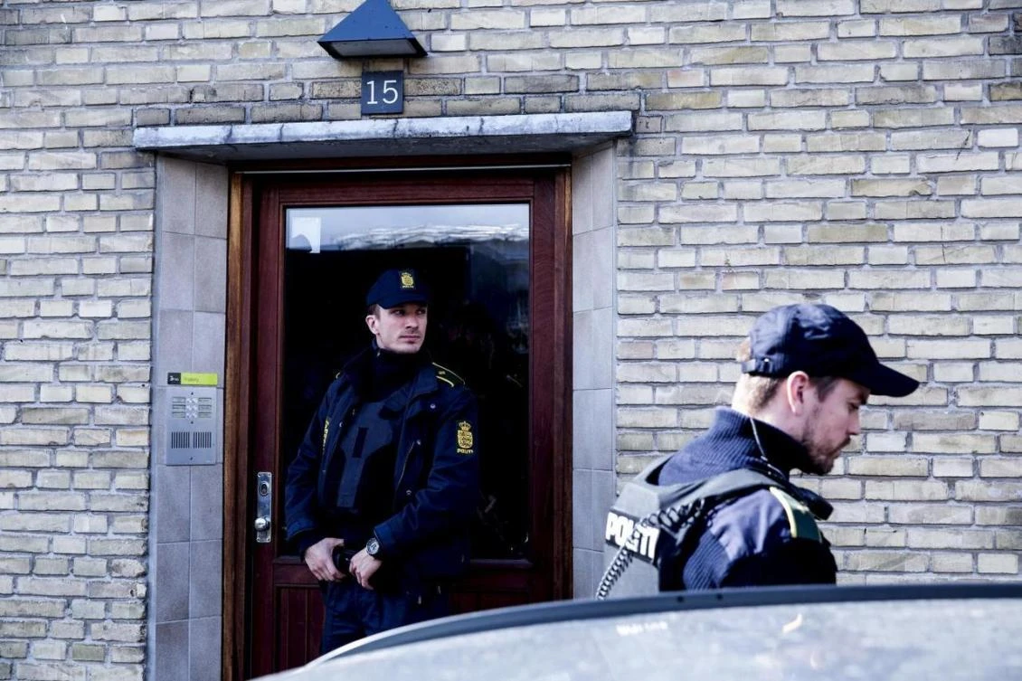 Policemen stand guard in an apartment block during a search for suspects believed to have traveled to Syria to join Daesh, in Tingbjerg, Copenhagen, in 2016. (Reuters)