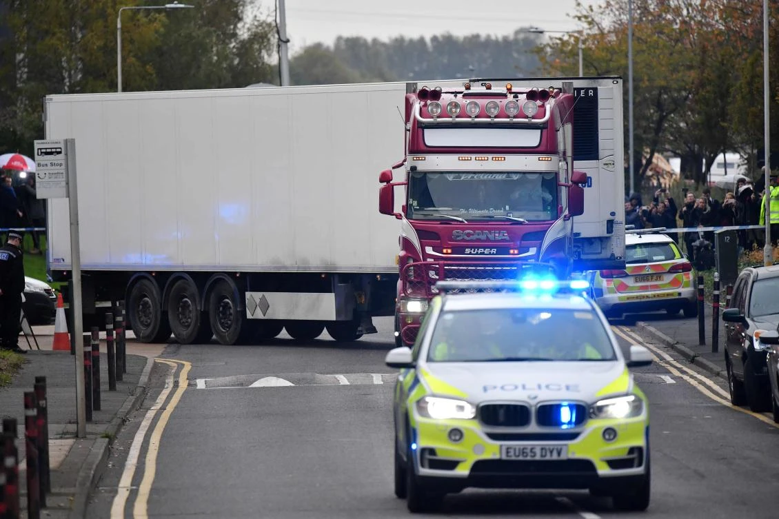 Police officers drive away a lorry in which was discovered 39 dead bodies, at Waterglade Industrial Park in Grays, east of London, on October 23, 2019. (AFP)