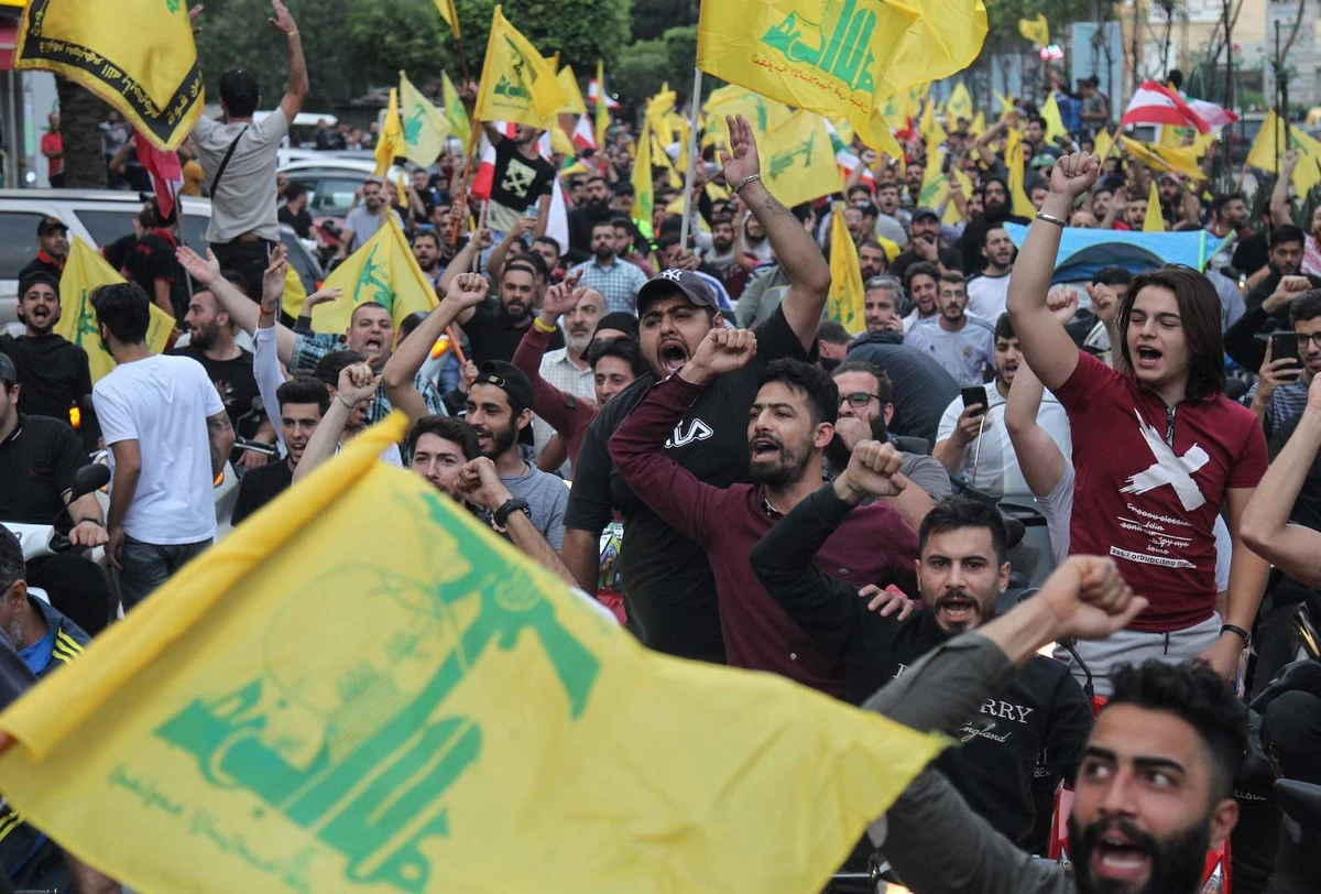 Supporters of the Shiite Hezbollah movement drive in a convoy in support of its leader Hassan Nasrallah's speech, in the southern suburbs of Beirut on October 25, 2019. (AFP)