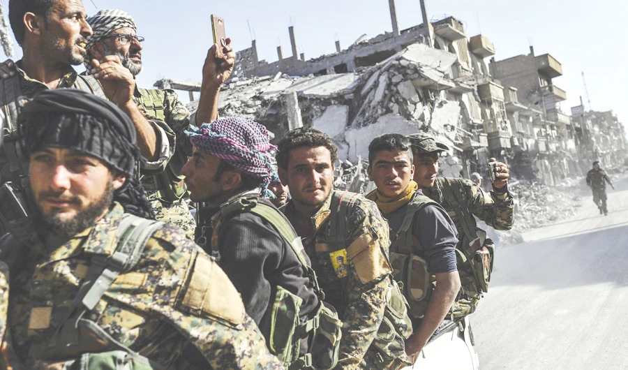 Fighters of the Kurdish-led SDF in Raqqa. The SDF says it might join Syrian army. (AFP)