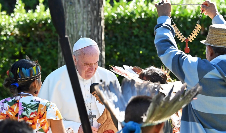 In this file photo taken on October 04, 2019 Pope Francis receives gifts from indigenous representatives of the Amazonian communities, carrying a carved wooden statue of a pregnant woman (C) symbolizing fertility, in the Vatican gardens before the Amazon synod that will take place on October 6, 2019. (AFP)