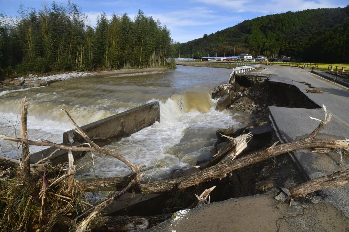 A part of Fukushima prefectural road is damaged by floodwaters after torrential rain in Iwaki city, Fukushima prefecture, northeast of Tokyo, Saturday, Oct. 26, 2019.
