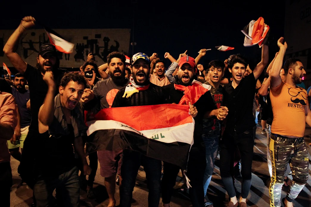 Demonstrators wave the Iraqi national flags at the Tahrir Square in Baghdad on October 24, 2019 as they protest against the country's political system.(AFP)