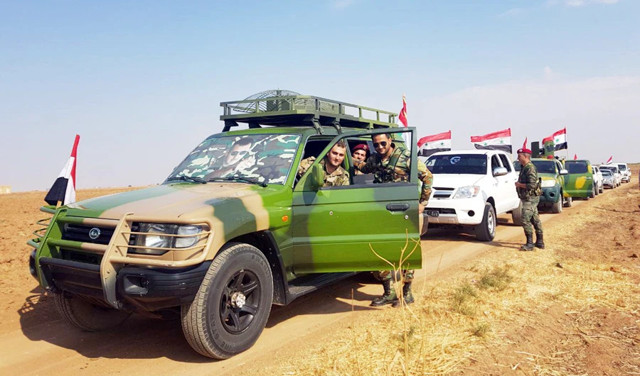 A handout picture released by the official Syrian Arab News Agency (SANA) on October 26, 2019, shows a convoy of the Syrian army on a road between the northeastern cities of Tal Tamer and Rasal-Ayn in the Hasake province. (AFP)