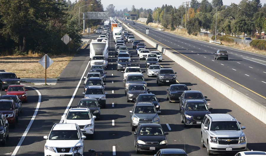 Vehicles travel South along Highway 101 as residents evacuate towns and cities in anticipation of the expected wind event on October 26, 2019 in Windsor, California. (AFP)