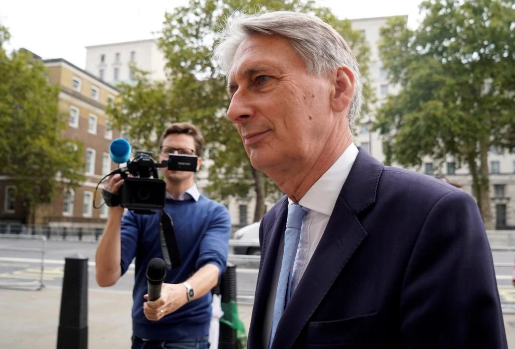 Britain’s former finance minister Philip Hammond said the government should ‘stop throwing tantrums and get on with the grown up business of doing its business.’ (AFP)