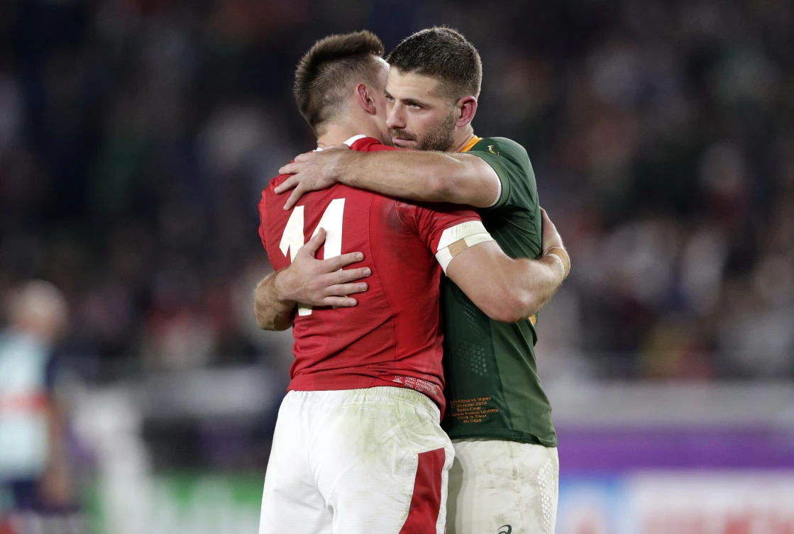 South Africa's Handre Pollard, right, hugs Wales' Josh Adams following their Rugby World Cup semifinal at International Yokohama Stadium in Yokohama, Japan, Sunday, Oct. 27, 2019. (AP)