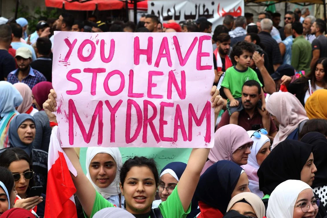 Students take part in an anti-government demonstration in the Lebanese southern port city of Sidon (Saida) on October 23, 2019. (AFP)