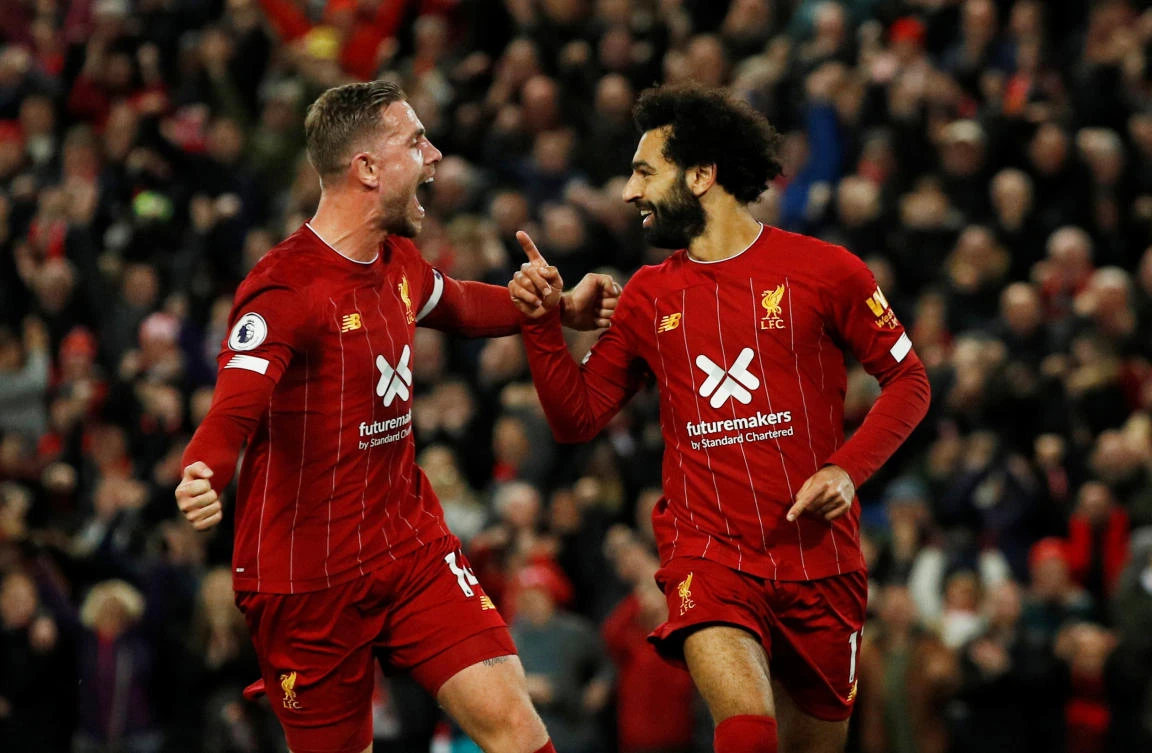 Liverpool's Mohamed Salah celebrates scoring their second goal with Jordan Henderson. (Reuters)