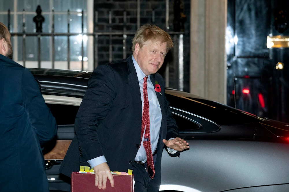 Boris Johnson arrives back at 10 Downing Street after MPs voted to hold an election in December. (AP)