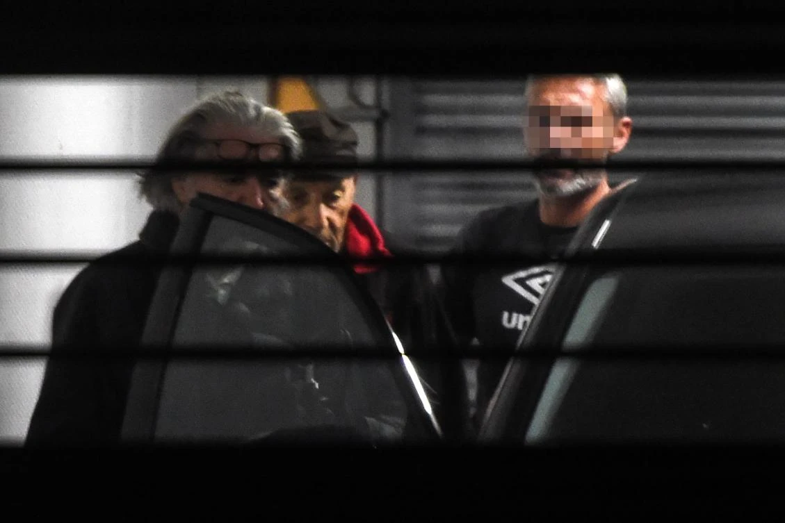 Claude Sinke (C), the octogenarian accused of wounding two men in a shooting at a mosque in southern France and his lawyer Benoit Briffe (L) enter a police car before leaving the Bayonne courthouse on October 30, 2019 where Sinke was charged and ordered held in detention. (AFP)