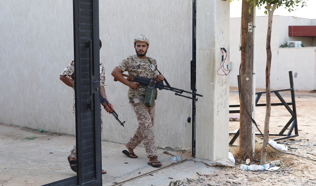 Members of Libya's internationally recognized government forces carry weapons in Ain Zara, Tripoli, Libya. (Reuters)