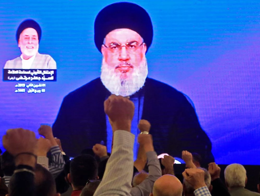 Supporters of Hassan Nasrallah, the head of Lebanon's militant Shiite Hezbollah movement, watch him speak through a giant screen at a mosque in the Lebanese capital Beirut's southern suburbs on Friday. (AFP)