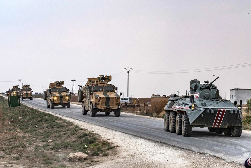 Russian (front) and Turkish military vehicles patrol in the countryside of Darbasiyah town in Syria's northeastern Hasakeh province on the Syrian-Turkish border on November 1, 2019. (AFP / Delil Souleiman)