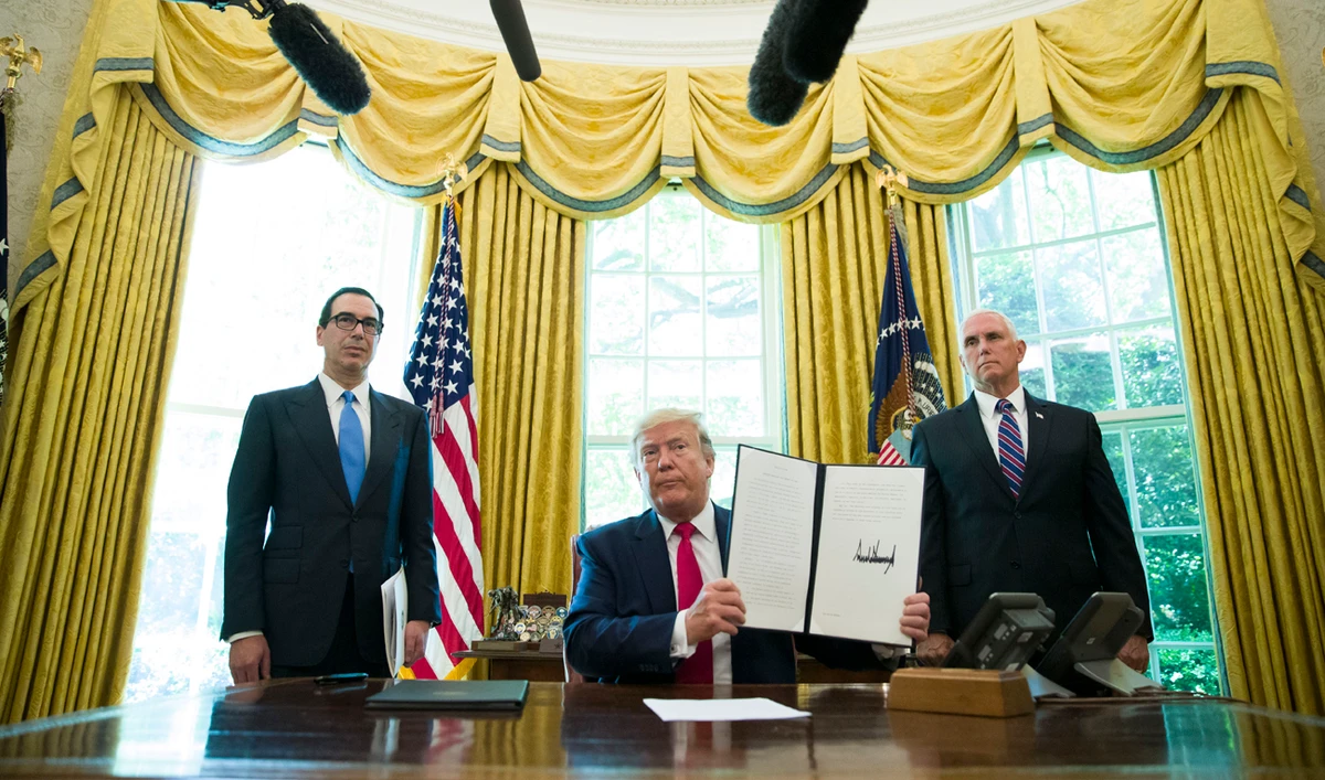 US President Donald Trump holds up a signed executive order to increase sanctions on Iran. (File/AP)