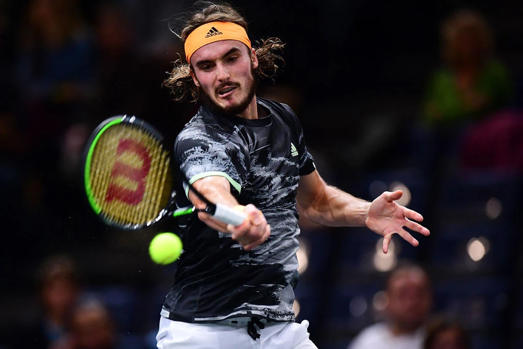 Greece's Stefanos Tsitsipas returns the ball to Serbia's Novak Djokovic during their men's singles quarter-final tennis match at the ATP World Tour Masters 1000 - Rolex Paris Masters - indoor tennis tournament at The AccorHotels Arena in Paris on November 1, 2019. (AFP / MARTIN BUREAU)