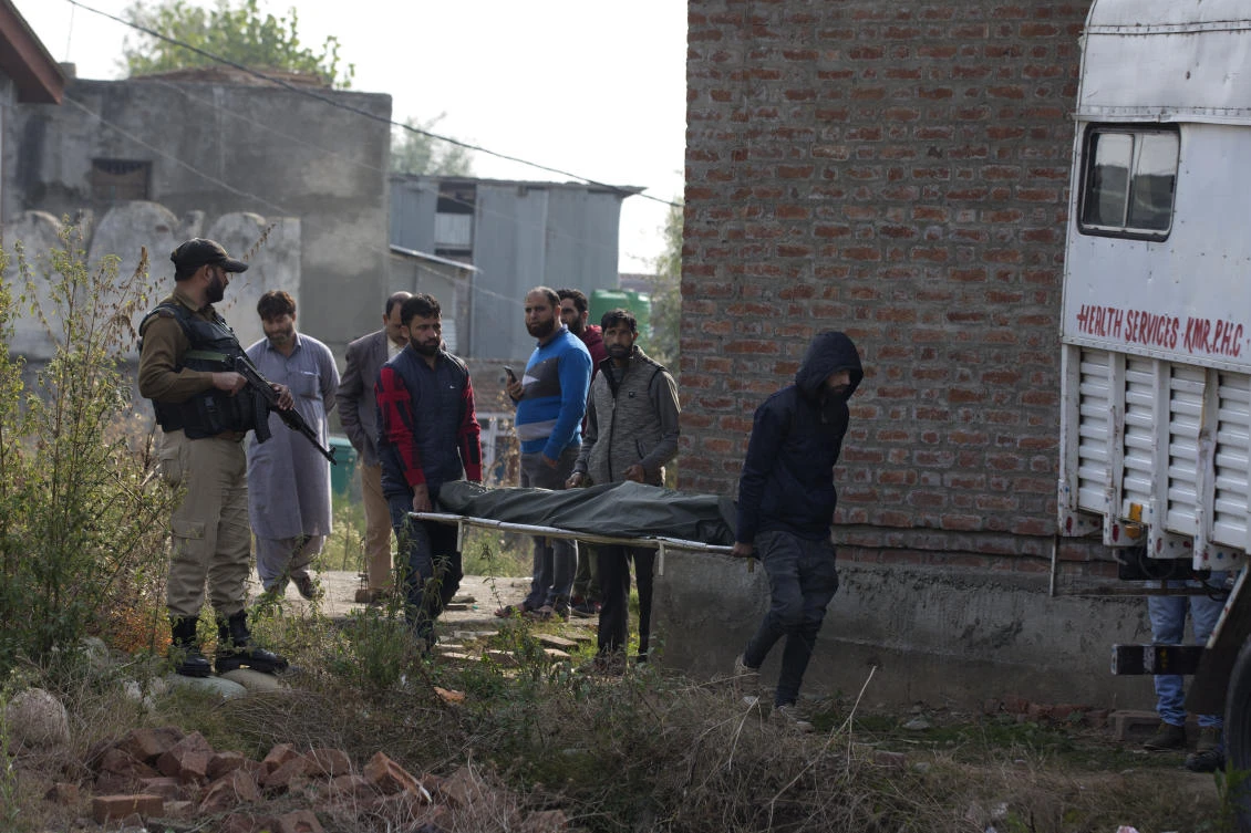 Kashmiri villagers carry the body of a migrant worker who was shot dead by gunmen south of Srinagar in Indian controlled Kashmir. (AP)