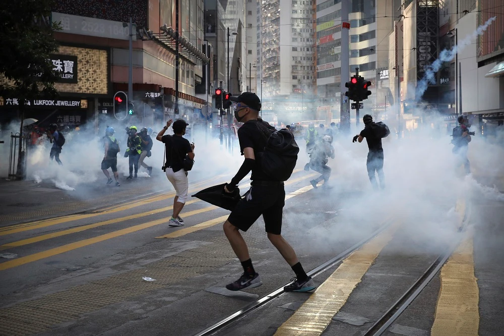 Protesters react as police fire tear gas during a protest in Hong Kong, Saturday, Nov. 2, 2019. (AP)