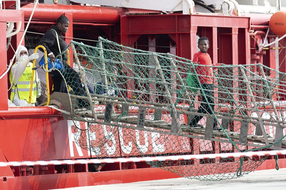 Migrants disembark from the humanitarian rescue ship Ocean Viking after it docked at the port of Pozzallo, in Sicily, southern Italy, on Oct. 30, 2019. The migrants were rescued off Libya on Oct. 18. On Nov. 1, the rescue vessel Asso Trenta also saved some 200 migrants in waters off Libya. (Francesco Ruta/ANSA via AP)