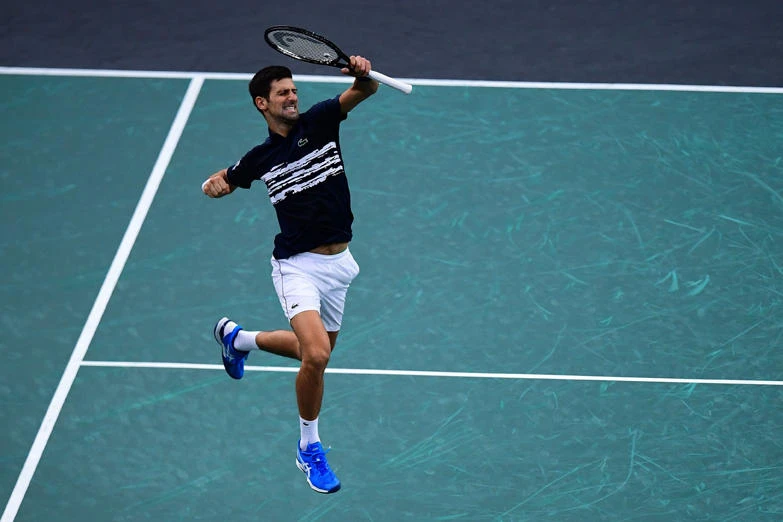 Serbia's Novak Djokovic celebrates winning against Canada's Denis Shapovalov during their men's singles final tennis match at the ATP World Tour Masters 1000 indoor tennis tournament at The AccorHotels Arena in Paris on Nov. 3, 2019. (AFP / MARTIN BUREAU)